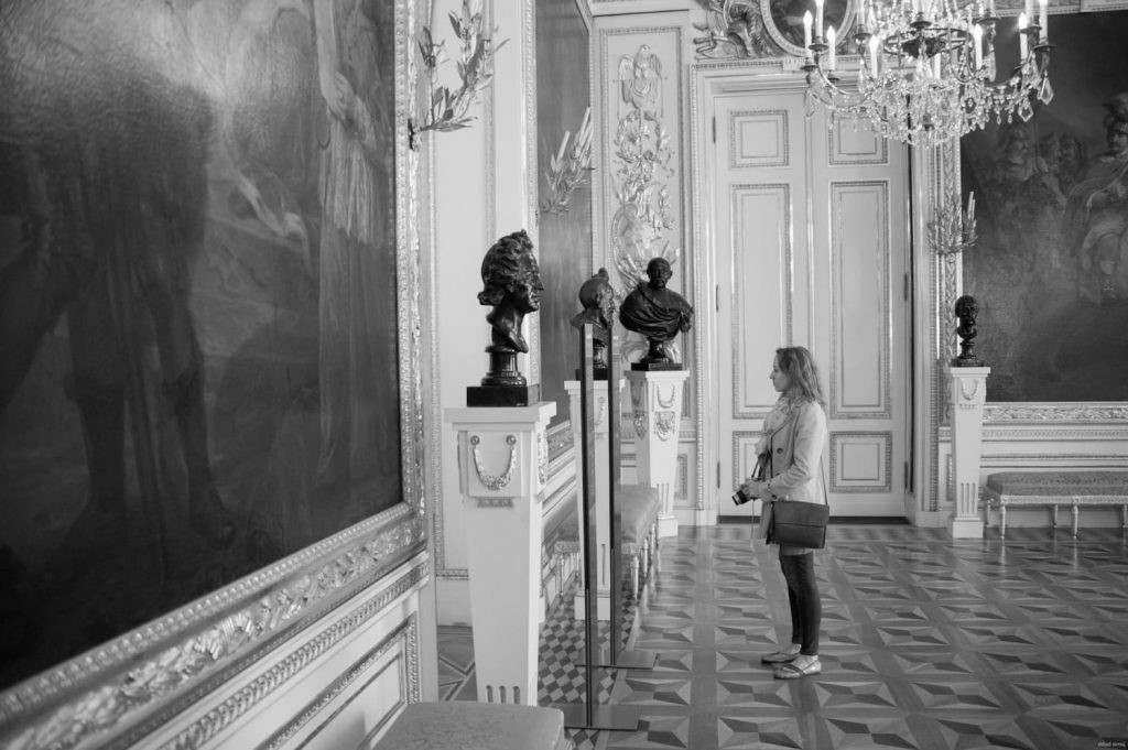 Visitor exploring an ornate gallery in Warsaw.