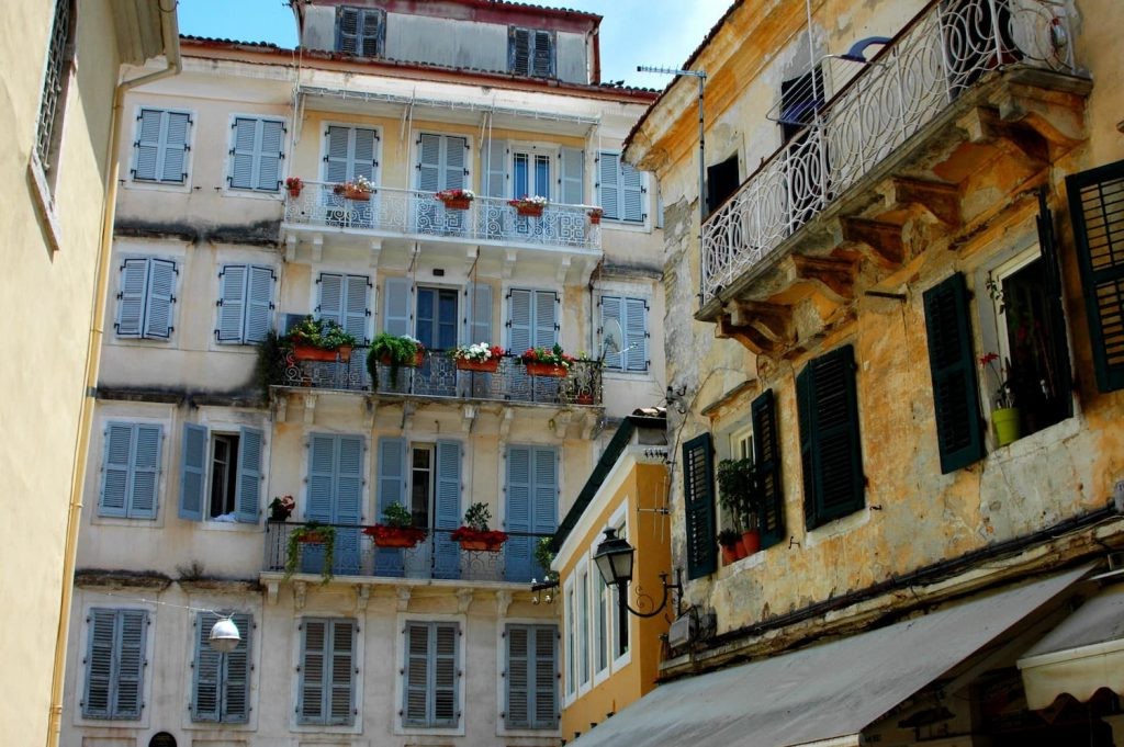 Rustic buildings with shutters and balconies in Corfu Town