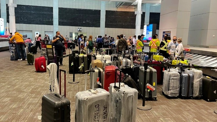 Randomly stacked luggage in arrivals hall