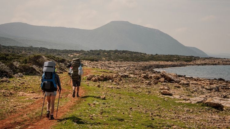 Solo traveler and companion hiking