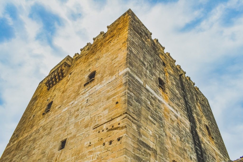 Close-up of a medieval stone tower with crenellations in Cyprus.