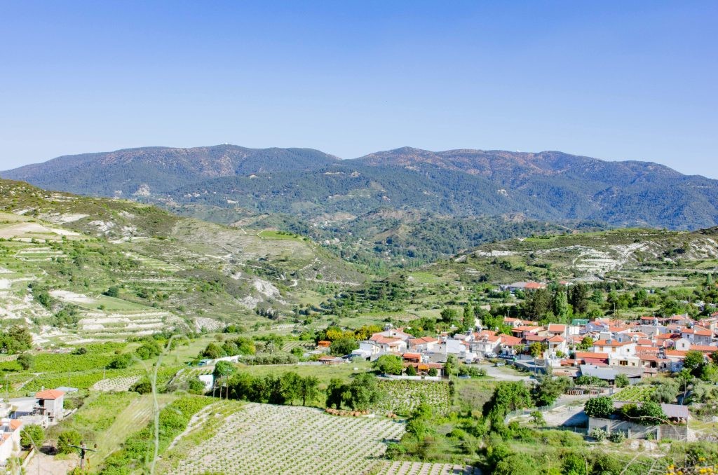 Green valleys and a small village nestled in the Troodos Mountains.
