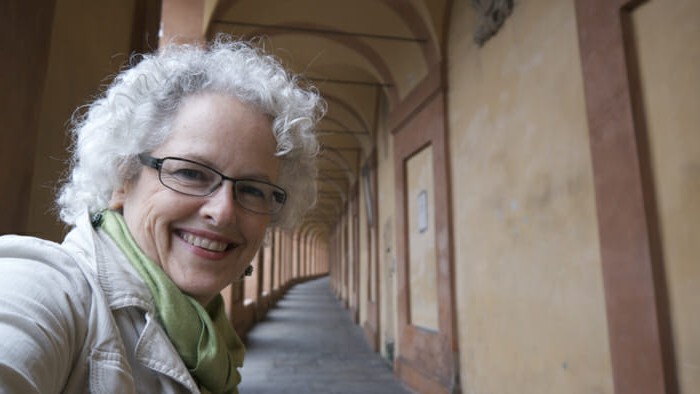 Travel selfie while walking under Bologna’s porticos to San Luca