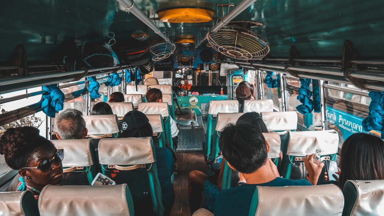 Travelers on a shuttle bus to a music festival